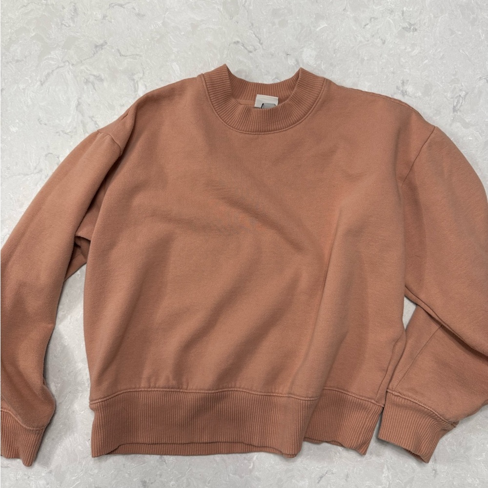 orange/peach colored sweater size medium